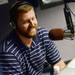 Former Michigan football player Jeff Backus smiles as she speaks on air during the Mott Takeover at 1050 WTKA on Friday, May 17, 2013. Backus retired from 12 years with the Detroit Lions this year. Melanie Maxwell I AnnArbor.com